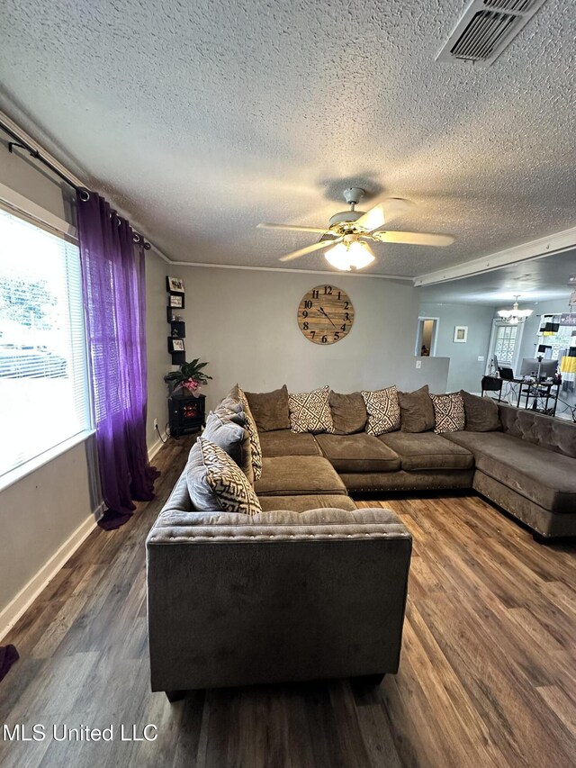 1420 S 9th Ave, Columbus, MS 39701 - living area with visible vents, a ceiling fan, a textured ceiling, and wood finished floors