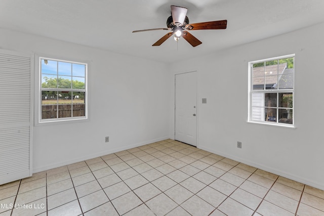 spare room with baseboards and ceiling fan