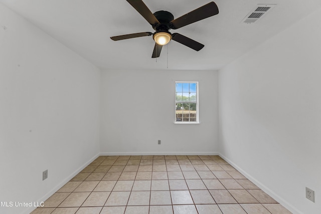 empty room with a ceiling fan, baseboards, visible vents, and light tile patterned flooring
