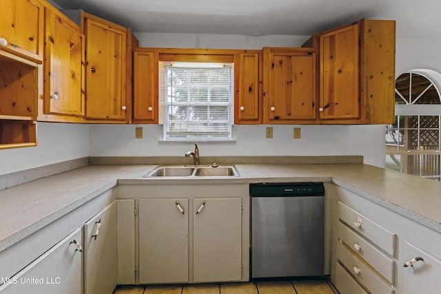 kitchen with a sink, light countertops, and stainless steel dishwasher