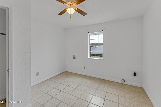 unfurnished room featuring baseboards, ceiling fan, and light tile patterned floors