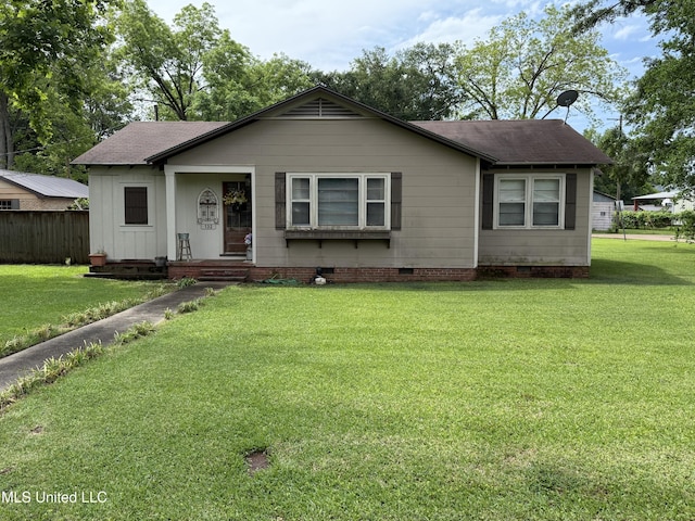 view of front facade featuring fence, a shingled roof, a front yard, and crawl space
