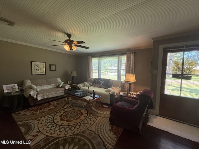 living area with crown molding, a ceiling fan, visible vents, and wood finished floors