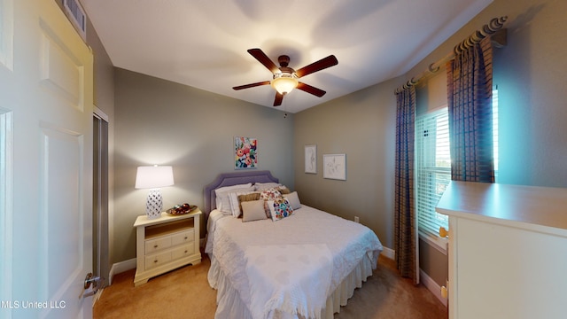 bedroom featuring light colored carpet and ceiling fan