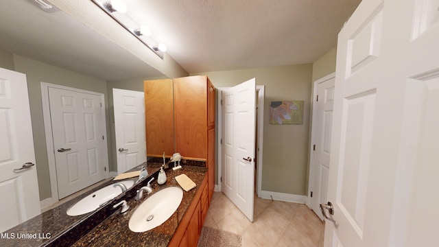 bathroom featuring vanity, a textured ceiling, and tile patterned flooring