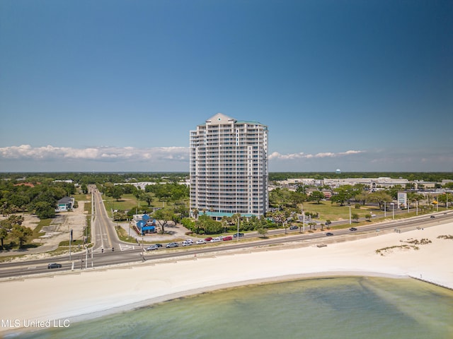 drone / aerial view featuring a water view and a view of the beach