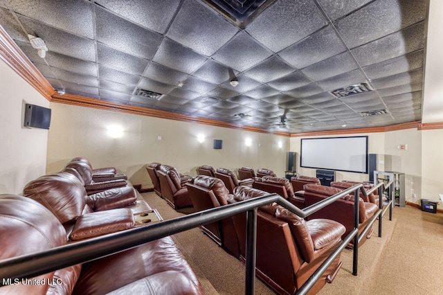 home theater featuring ornamental molding, carpet flooring, ceiling fan, and a drop ceiling