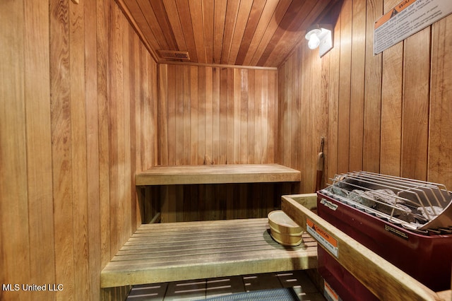 view of sauna with wood walls and wooden ceiling