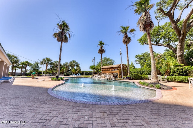 view of swimming pool with a patio and pool water feature