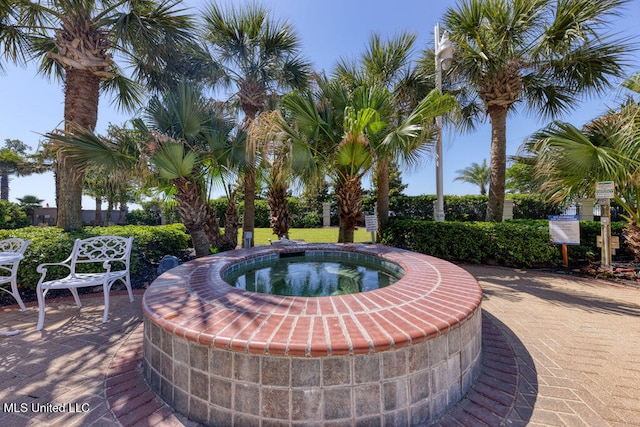 exterior space featuring an in ground hot tub