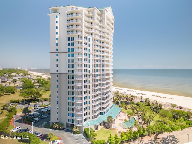 view of property with a view of the beach and a water view