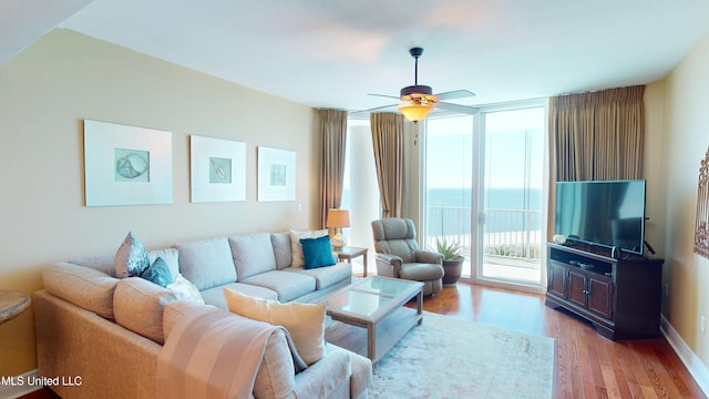 living room featuring light wood-type flooring and ceiling fan