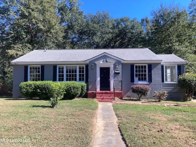 ranch-style home with a front yard