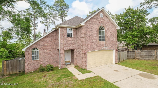 traditional-style house with a garage, brick siding, fence, and a front yard