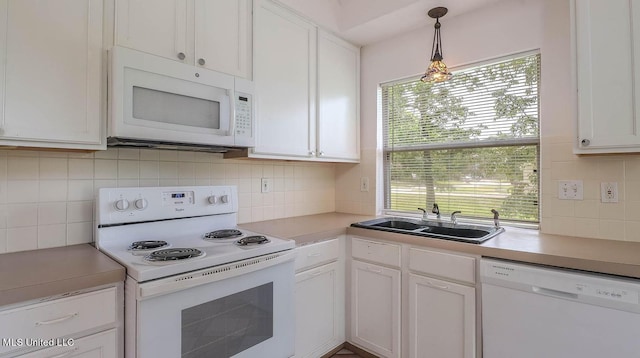 kitchen featuring white appliances, a sink, light countertops, white cabinetry, and backsplash