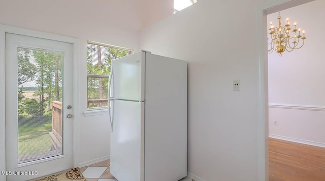 entryway with baseboards and an inviting chandelier