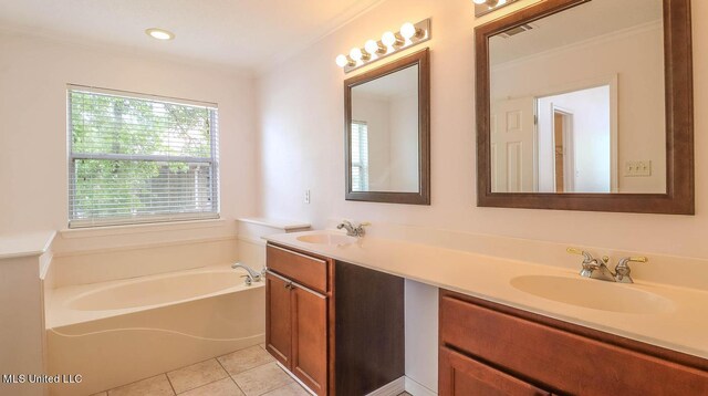 full bathroom with a garden tub, double vanity, tile patterned flooring, and a sink