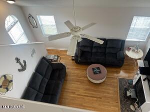 living room with a ceiling fan and wood finished floors