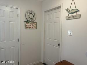 doorway to outside featuring baseboards