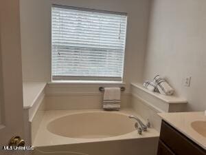 full bathroom featuring a garden tub and vanity