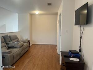 living room with visible vents and wood finished floors