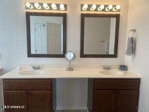 full bath with double vanity and a sink