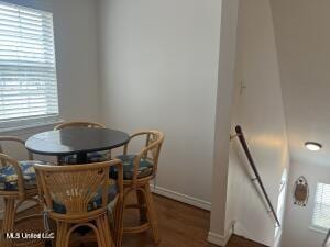 dining area featuring baseboards and wood finished floors