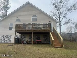 back of property with stairway, a deck, and a yard