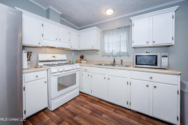 kitchen featuring under cabinet range hood, ornamental molding, stainless steel appliances, and a sink