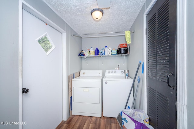 laundry room featuring washing machine and dryer, a textured ceiling, laundry area, and dark wood-style flooring