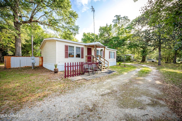 manufactured / mobile home featuring fence and driveway