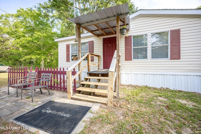 property entrance featuring a patio
