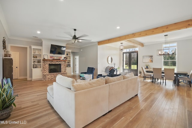 13240 Wolf River Rd, Gulfport, MS 39503 - living room with recessed lighting, a brick fireplace, ceiling fan with notable chandelier, and light wood-style flooring