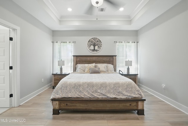 13240 Wolf River Rd, Gulfport, MS 39503 - bedroom featuring visible vents, baseboards, wood finished floors, and a tray ceiling