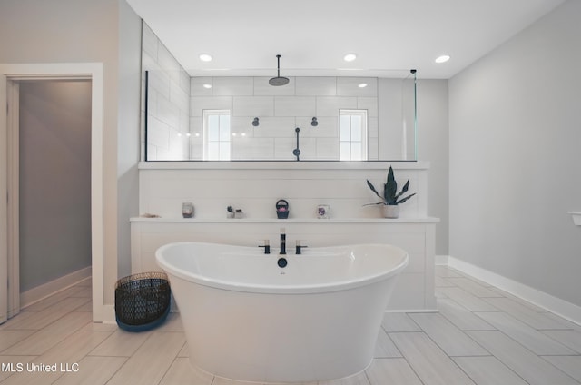 13240 Wolf River Rd, Gulfport, MS 39503 - full bathroom featuring recessed lighting, a tile shower, a freestanding tub, and baseboards