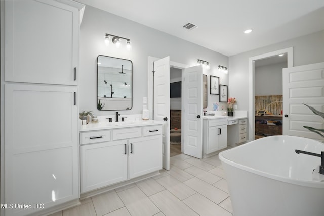 13240 Wolf River Rd, Gulfport, MS 39503 - bathroom with a soaking tub, two vanities, visible vents, and a sink