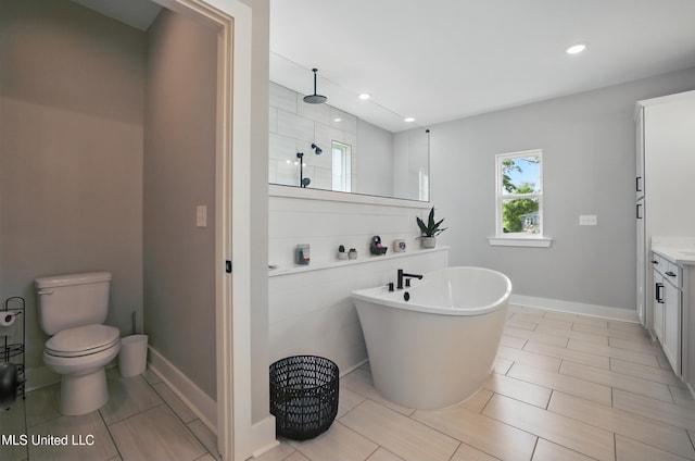 13240 Wolf River Rd, Gulfport, MS 39503 - bathroom featuring a freestanding tub, vanity, walk in shower, toilet, and recessed lighting