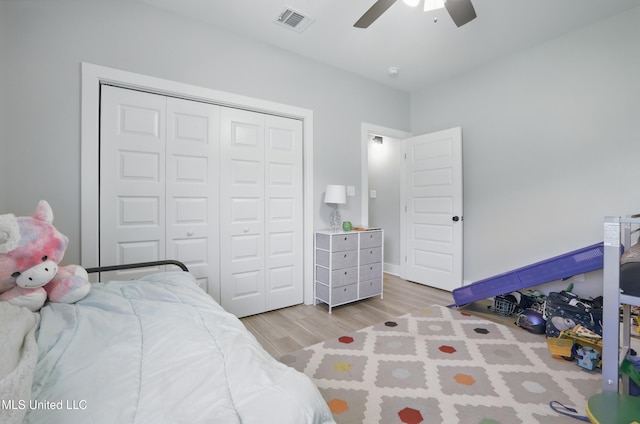 13240 Wolf River Rd, Gulfport, MS 39503 - bedroom featuring a closet, light wood-style floors, visible vents, and ceiling fan