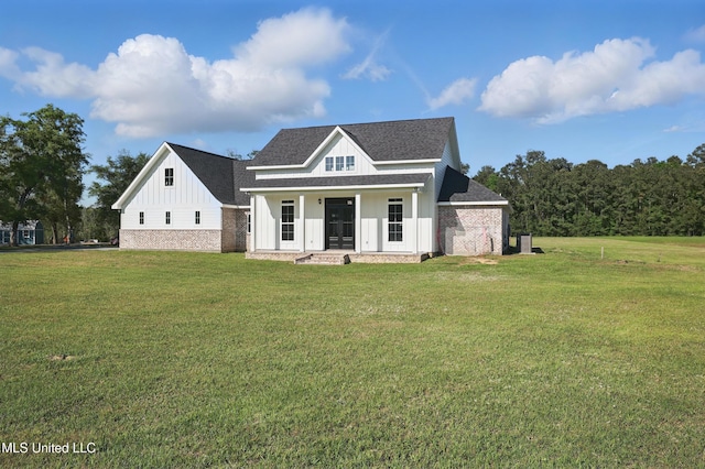 13240 Wolf River Rd, Gulfport, MS 39503 - view of front facade with a front lawn, roof with shingles, and board and batten siding