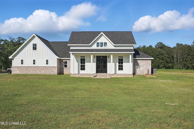 13240 Wolf River Rd, Gulfport, MS 39503 - view of front facade with roof with shingles, covered porch, brick siding, board and batten siding, and a front yard