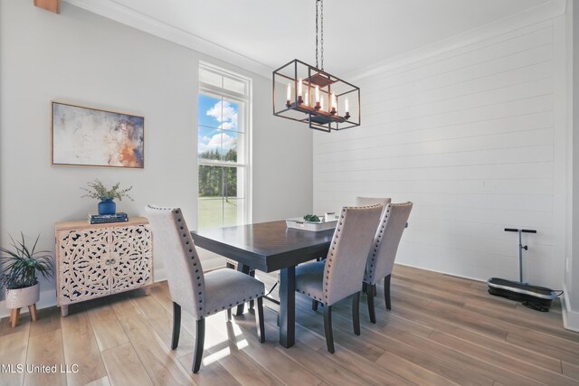 13240 Wolf River Rd, Gulfport, MS 39503 - dining room featuring wood finished floors, an inviting chandelier, and ornamental molding