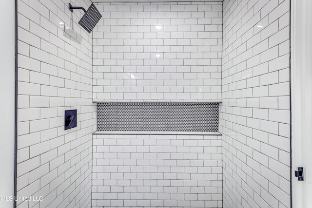 bathroom with a tile shower