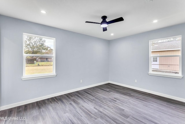 unfurnished room with ceiling fan and dark wood-type flooring