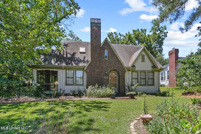 tudor house featuring a front yard