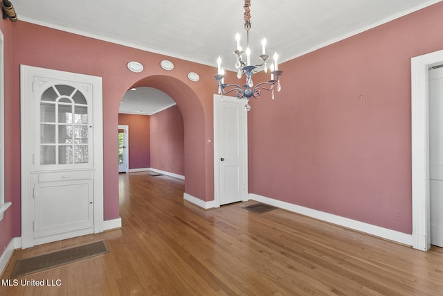 1521 Riverside Dr, Jackson, MS 39202 - unfurnished dining area with a chandelier, light wood-style floors, visible vents, and baseboards