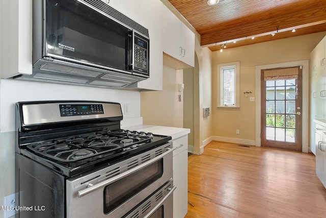 kitchen with white cabinetry, wood ceiling, stainless steel gas range oven, and light wood-type flooring