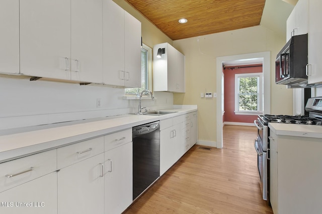 1521 Riverside Dr, Jackson, MS 39202 - kitchen with a sink, black appliances, wooden ceiling, light countertops, and white cabinets