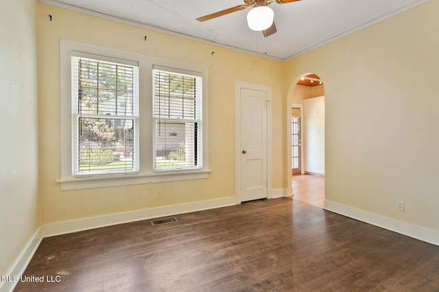 spare room featuring crown molding, dark hardwood / wood-style floors, and ceiling fan