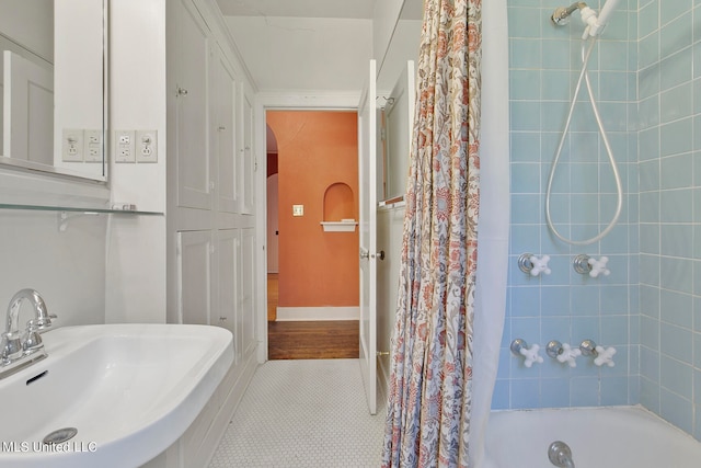 bathroom with shower / bath combination with curtain, tile patterned floors, and sink