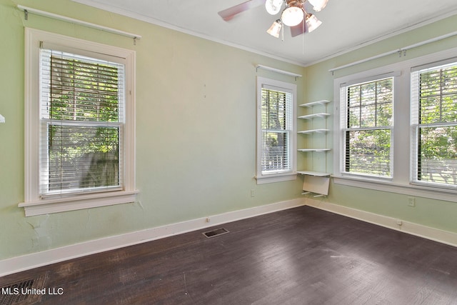 empty room with ornamental molding, dark hardwood / wood-style floors, and ceiling fan